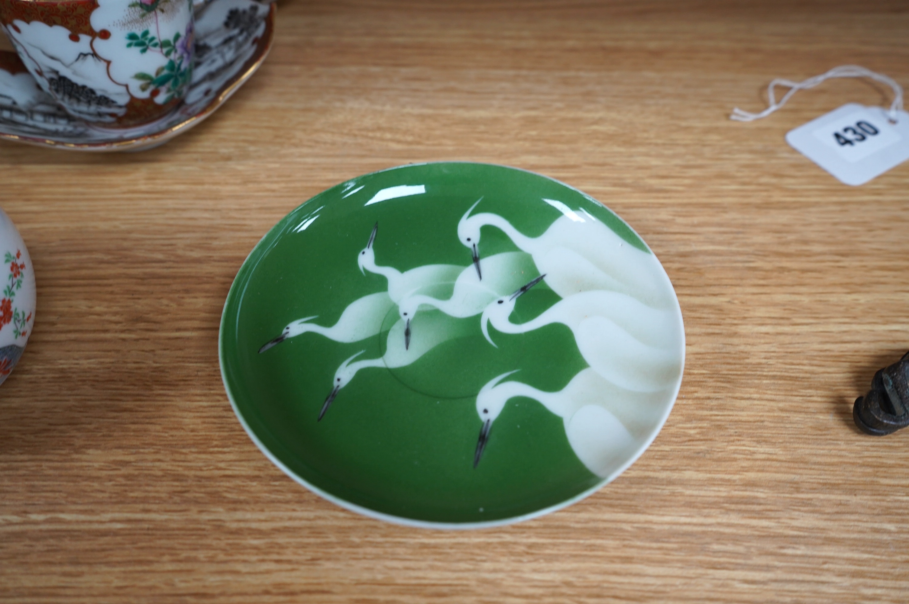 A group of Chinese and Japanese ceramics to include Yixing teapots, porcelain cups and saucers, a blue and white vase and a tiger talisman. Condition - mostly good